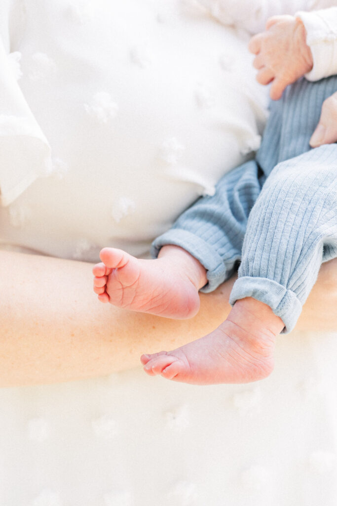 An Austin Newborn Photographer captures a detailed shot of a newborn baby's feet during an outdoor newborn photo session at Katherine Fleischer Park. 