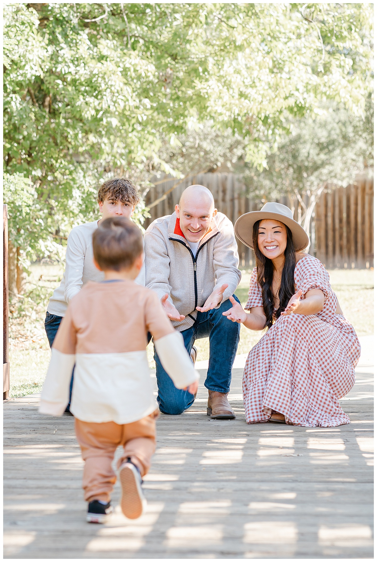 Best Photo Locations in Austin | A little boy runs toward his parents and older brother on a bridge at Katherine Fleischer Park