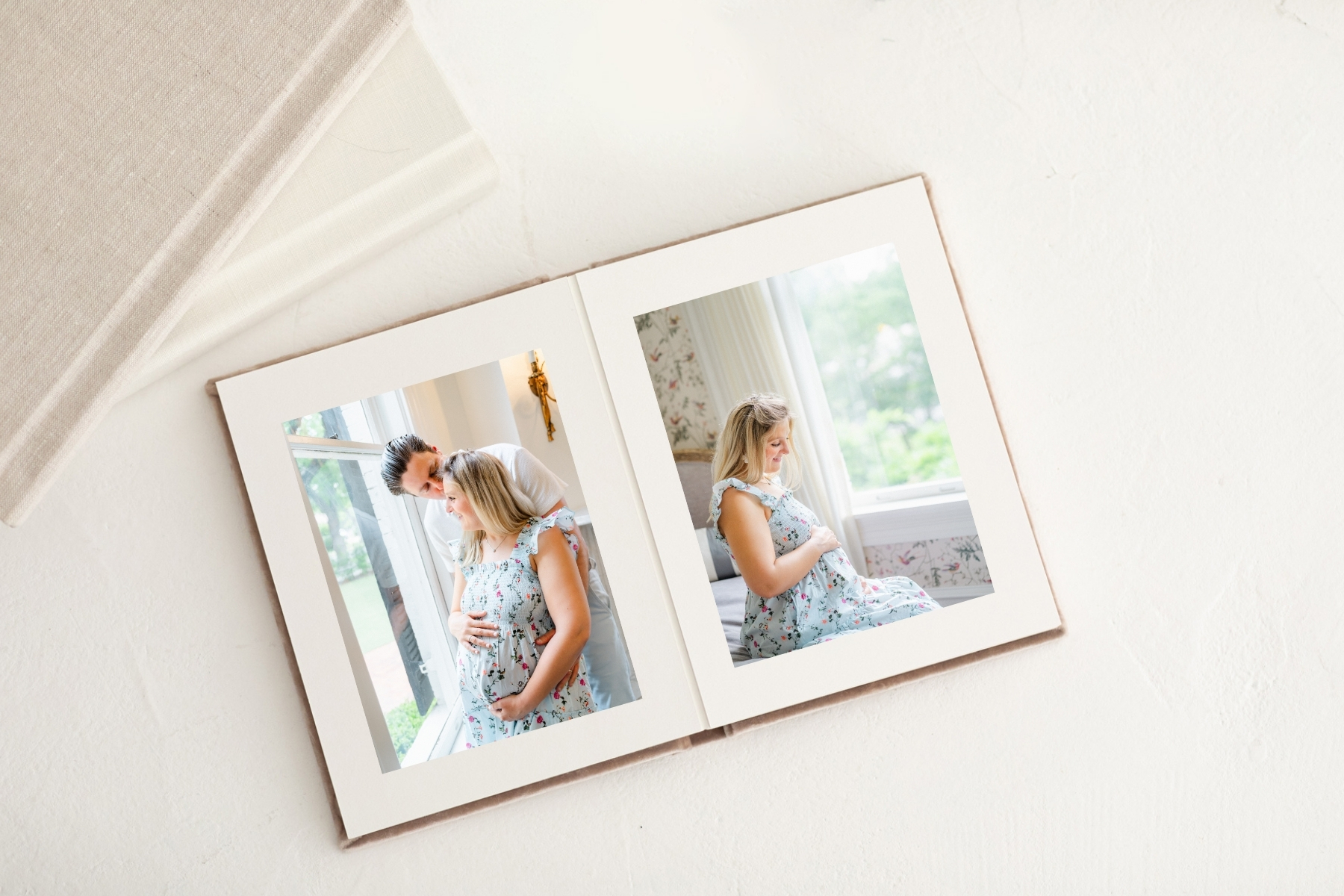 photo of a photo album displayed on a white background. The album displays photos from a maternity session at the Woodbine Mansion, captured by an Austin TX Photographer.