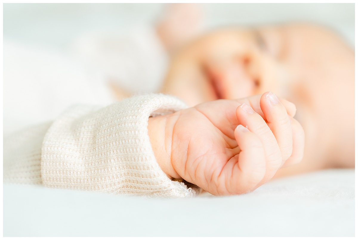 close-up photo of a newborn baby's hand laying on a bed during his newborn session in Leander, TX.