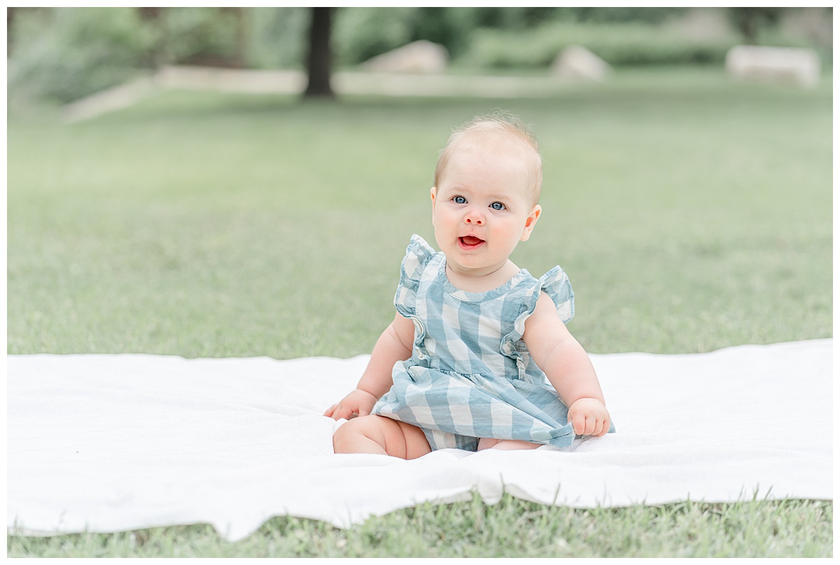 Austin Baby Photography: 6-month baby girl sitting on a white blanket at Katherine Fleischer Park