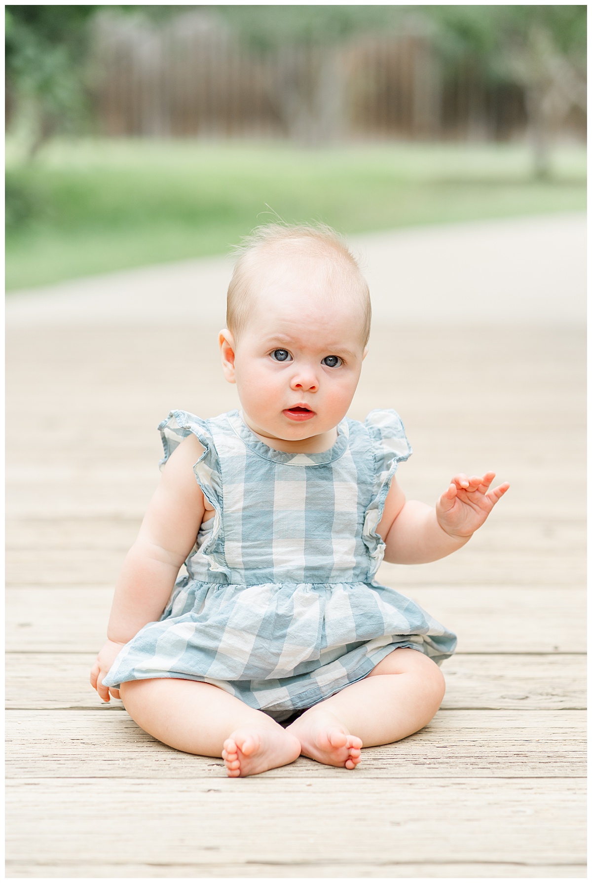 Austin Photographer | A baby girl sits on a bridge at Katherine Fleischer park during her 6-months milestone session.