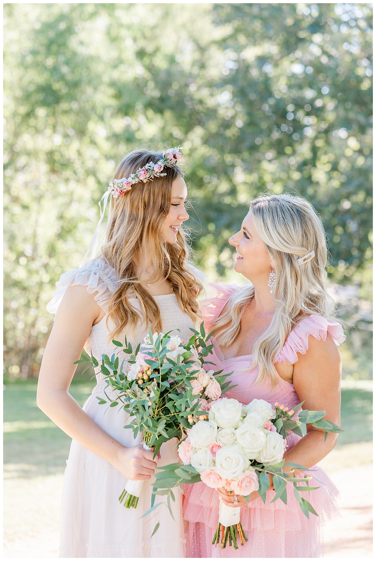 A mother and her teenage daughter look at each other while smiling during their family photoshoot at an Austin park.