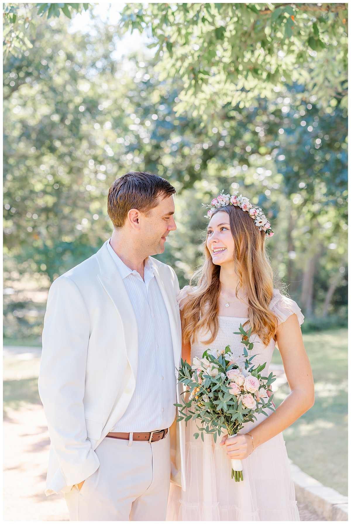 A father and his teenage daughter look at each other with a smile during their Austin family photos.