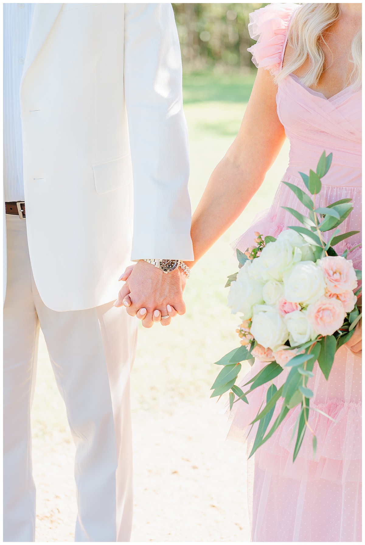 detail shot of a couple holding hands with a fresh bouquet of flowers during their anniversary photos at an Austin park.