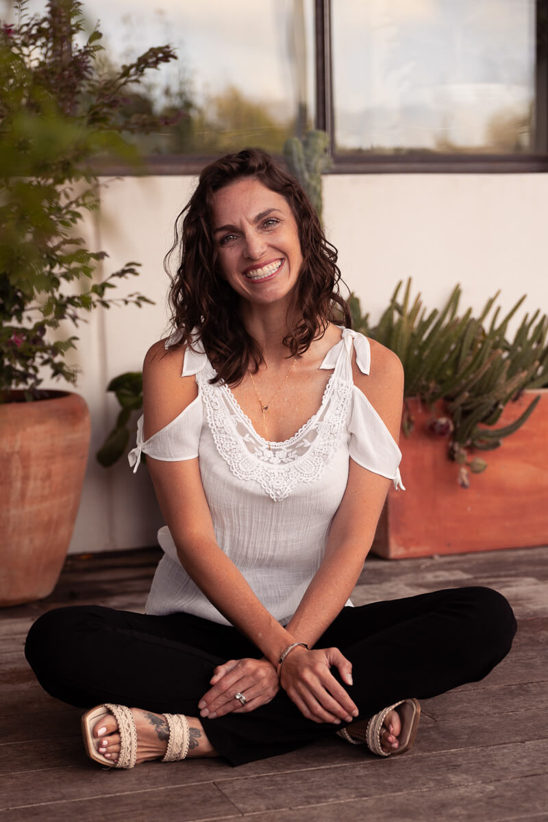 an Austin doula sits on the floor with her legs crossed.